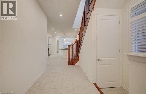 Foyer featuring neutral wall tones, recessed lighting, tile flooring, and a hardwood staircase with traditional balusters - 52 Pointer Street, Cambridge, ON - Indoor Photo Showing Other Room