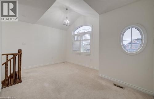 Carpeted interior space featuring a vaulted ceiling with a chandelier - 52 Pointer Street, Cambridge, ON - Indoor Photo Showing Other Room