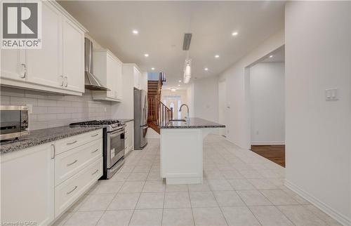 Modern kitchen featuring white shaker cabinetry, stainless steel appliances, granite countertops, and a subway tile backsplash - 52 Pointer Street, Cambridge, ON - Indoor Photo Showing Kitchen With Upgraded Kitchen