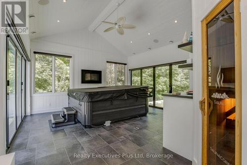 Sunroom with Hotub & Gas FP off Kitchen - 27 Kingfisher Crescent, Tiny, ON - Indoor Photo Showing Other Room