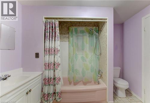 Bathroom featuring a built-in bathtub with shower, toilet, and a vanity with an integrated sink and base cabinetry - 224 Weber Street E, Kitchener, ON - Indoor Photo Showing Bathroom
