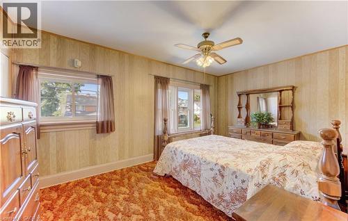 BedRoom featuring paneling walls, textured carpeting, and a ceiling fan with integrated lighting - 224 Weber Street E, Kitchener, ON - Indoor Photo Showing Bedroom
