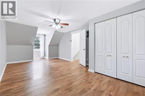 Spacious room featuring wood-finish flooring, light grey walls, and a multi-pane window - 34 Peachtree Crescent, Cambridge, ON - Indoor Photo Showing Other Room