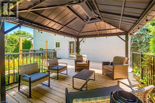 Expansive wood-finish deck featuring a permanent gazebo with integrated lighting - 34 Peachtree Crescent, Cambridge, ON - Outdoor With Deck Patio Veranda With Exterior