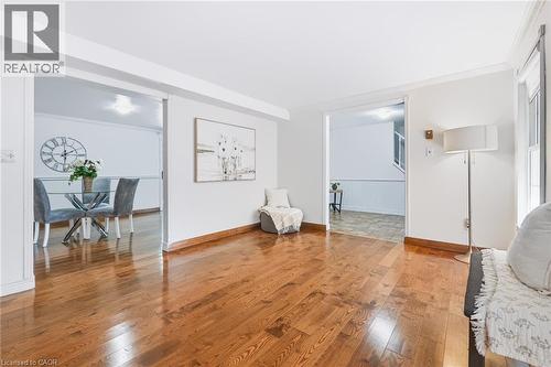 Warm wood-finish flooring extends through this open living area - 34 Peachtree Crescent, Cambridge, ON - Indoor Photo Showing Other Room