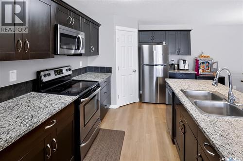 113 125 Willis Crescent, Saskatoon, SK - Indoor Photo Showing Kitchen With Double Sink