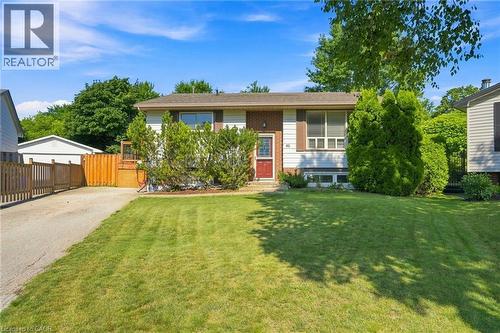 Split-level home featuring a red entry door, white siding, and a partial brick facade - 46 Brett Court, Hamilton, ON - Outdoor