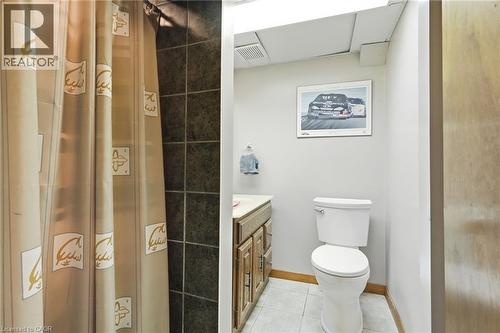 Bathroom featuring a white toilet, light wood-finish vanity with a light countertop, and light tile flooring - 46 Brett Court, Hamilton, ON - Indoor Photo Showing Bathroom