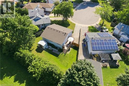 Property featuring a large array of rooftop solar panels, a spacious wooden deck, and a detached storage shed - 46 Brett Court, Hamilton, ON - Outdoor With View