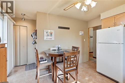 Kitchen space featuring light-toned tile flooring, light wood cabinetry, and a ceiling fan with integrated lighting - 46 Brett Court, Hamilton, ON - Indoor Photo Showing Dining Room
