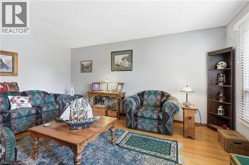 Brightly lit interior space featuring light-colored walls and wood-finish flooring - 46 Brett Court, Hamilton, ON - Indoor Photo Showing Living Room