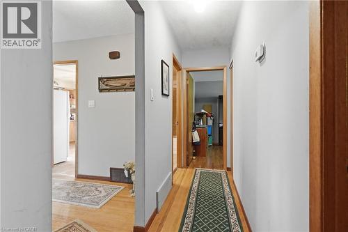 Hallway featuring hardwood flooring, light gray walls, and natural wood trim around doorways - 46 Brett Court, Hamilton, ON - Indoor Photo Showing Other Room