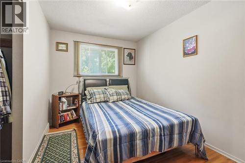 Bedroom featuring a single window, light-toned walls, and wood-finish flooring - 46 Brett Court, Hamilton, ON - Indoor Photo Showing Bedroom