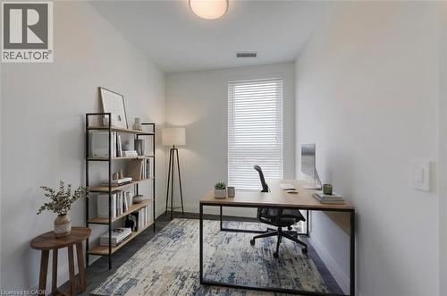 Bright room featuring a window with horizontal blinds, wood-finish flooring, and a ceiling-mounted light fixture - 1333 Weber Street E Unit# 708, Kitchener, ON - Indoor Photo Showing Office