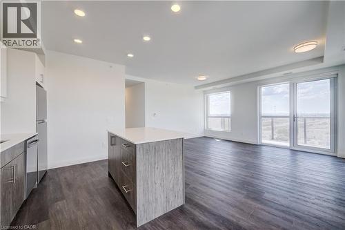 Open-concept living area with dark wood-finish flooring, white walls, and recessed ceiling lighting - 1333 Weber Street E Unit# 708, Kitchener, ON - Indoor Photo Showing Kitchen