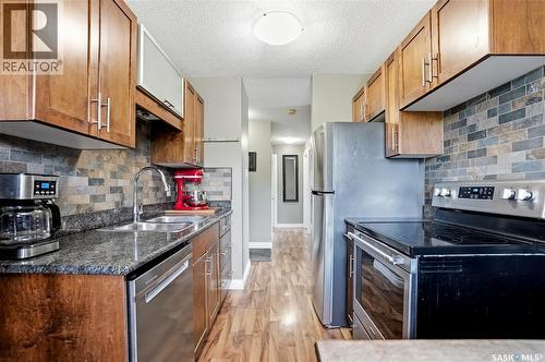 7 115 Acadia Drive, Saskatoon, SK - Indoor Photo Showing Kitchen With Stainless Steel Kitchen With Double Sink