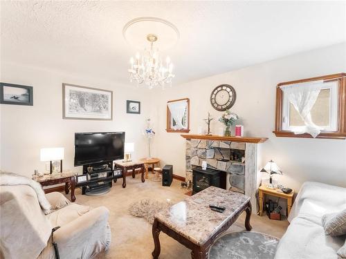 Another angel - 1069 Valour Road, Winnipeg, MB - Indoor Photo Showing Living Room With Fireplace
