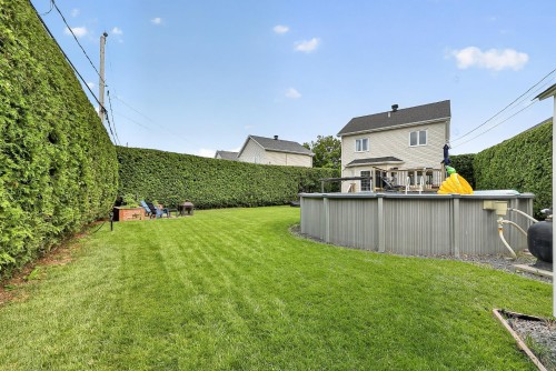 Face arrière - 38 Rue Toupin, Saint-Constant, QC - Outdoor With Above Ground Pool With Backyard