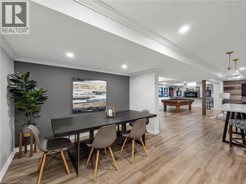 Spacious finished basement featuring wood-finish flooring, recessed lighting, crown molding, and a dedicated entertainment area with a pool table - 80 Sutherland Crescent, Ancaster, ON - Indoor Photo Showing Dining Room