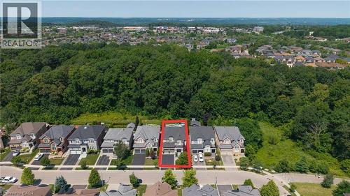 Contemporary residential property featuring a gray facade, dark roof, and an attached garage - 80 Sutherland Crescent, Ancaster, ON - Outdoor With View