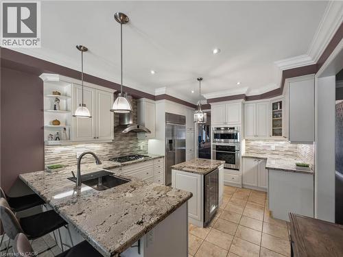 Kitchen featuring granite countertops, stainless steel appliances, white cabinetry, a tiled backsplash, and recessed lighting - 80 Sutherland Crescent, Ancaster, ON - Indoor Photo Showing Kitchen With Upgraded Kitchen