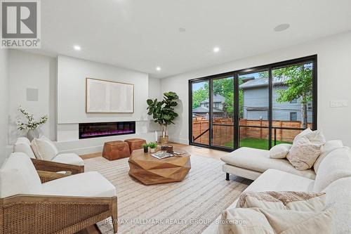 Double patio doors leads out to 2 tier deck. - 218 Woodland Avenue, Ottawa, ON - Indoor Photo Showing Living Room