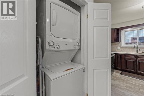 Stackable laundry center within a dedicated closet - 167 Berkindale Drive, Hamilton, ON - Indoor Photo Showing Laundry Room