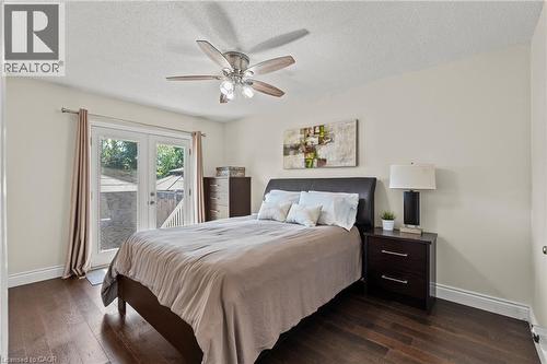 Spacious room featuring wood-finish flooring, a ceiling fan with integrated lighting, and a white popcorn ceiling - 167 Berkindale Drive, Hamilton, ON - Indoor Photo Showing Bedroom