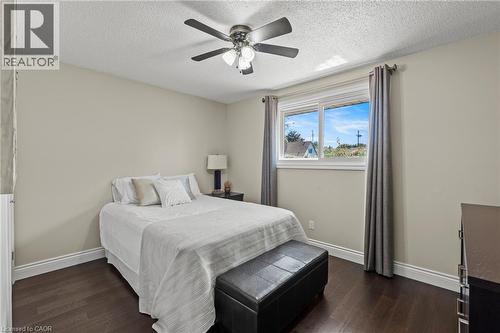 Bedroom featuring dark wood-finish flooring, light neutral wall paint, and white baseboard trim - 167 Berkindale Drive, Hamilton, ON - Indoor Photo Showing Bedroom