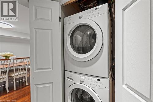 Dedicated laundry closet featuring a stacked white washer and dryer unit - 167 Berkindale Drive, Hamilton, ON - Indoor Photo Showing Laundry Room