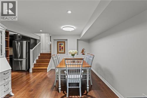 Open-concept dining area featuring wood-finish flooring, recessed lighting, and a contemporary ceiling fixture - 167 Berkindale Drive, Hamilton, ON - Indoor Photo Showing Dining Room