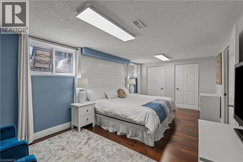 Bedroom featuring wood-finish flooring, two panel doors, a window with blinds, and recessed lighting - 167 Berkindale Drive, Hamilton, ON - Indoor Photo Showing Bedroom