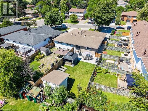 Expansive backyard featuring a manicured lawn, a paved patio area, and a large storage shed - 167 Berkindale Drive, Hamilton, ON - Outdoor