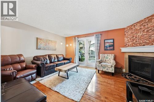 402 2703 Spadina Crescent E, Saskatoon, SK - Indoor Photo Showing Living Room With Fireplace