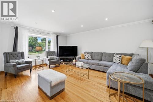 Spacious living area showcasing hardwood flooring, recessed ceiling lighting, and expansive windows with natural light - 6346 Neuchatel Road, Mississauga, ON - Indoor Photo Showing Living Room