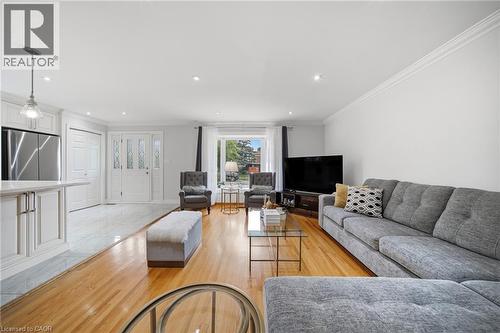 Open-concept living space featuring wood-finish flooring, recessed lighting, and crown molding - 6346 Neuchatel Road, Mississauga, ON - Indoor Photo Showing Living Room