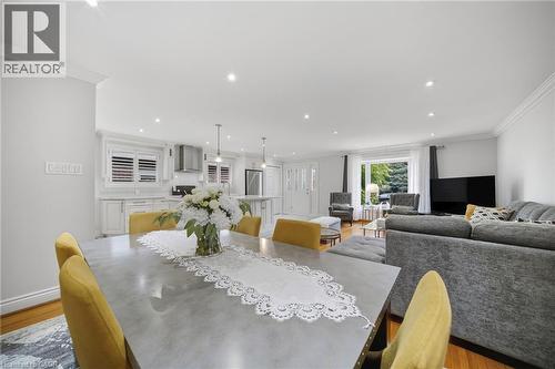 Open-concept living and dining area featuring recessed ceiling lights, pendant fixtures, and wood-finish flooring throughout - 6346 Neuchatel Road, Mississauga, ON - Indoor Photo Showing Dining Room