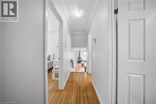 Bright hallway showcasing gleaming wood-finish flooring, crisp white painted walls, and clean-lined white six-panel doors - 6346 Neuchatel Road, Mississauga, ON - Indoor Photo Showing Other Room