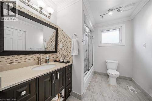 Spa-inspired primary bathroom featuring a dark wood vanity with dual sink configuration, quartz countertop, and polished chrome fixtures - 6346 Neuchatel Road, Mississauga, ON - Indoor Photo Showing Bathroom