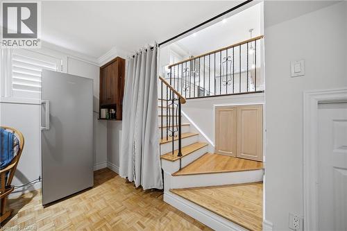 Bright, open foyer showcasing hardwood flooring, a prominent staircase with wooden treads and metal railings, and abundant natural light from multiple windows - 6346 Neuchatel Road, Mississauga, ON - Indoor Photo Showing Other Room