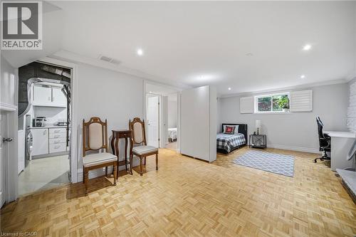 Expansive finished lower level featuring parquet wood flooring, recessed lighting, and a window with white shutters - 6346 Neuchatel Road, Mississauga, ON - Indoor