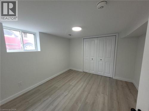 Room featuring light wood-finish flooring, white walls, and a window - 132 East 31St Street, Hamilton, ON - Indoor Photo Showing Other Room