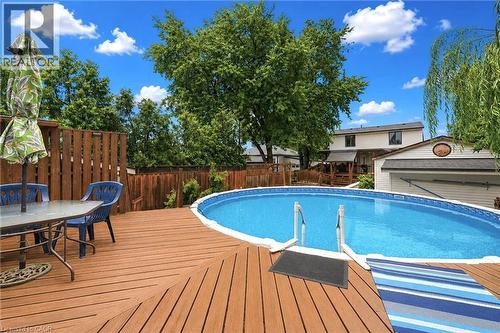 Sparkling in-ground swimming pool with white safety rails and vinyl liner, surrounded by a composite wood-finish deck - 450 East 42Nd Street, Hamilton, ON - Outdoor With Above Ground Pool