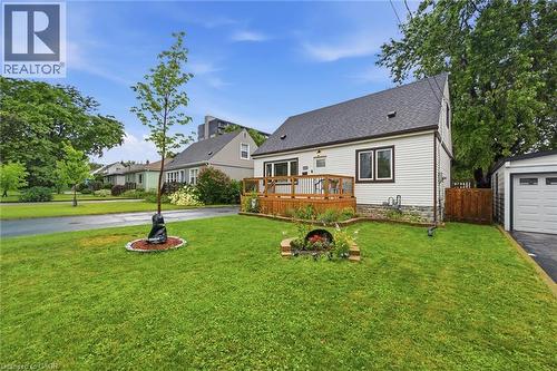 White siding exterior with a dark shingle roof and a wood deck - 450 East 42Nd Street, Hamilton, ON - Outdoor