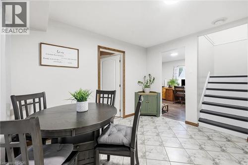Dining area featuring ceramic tile flooring, white wall finishes, and an open doorway leading to an additional space - 450 East 42Nd Street, Hamilton, ON - Indoor Photo Showing Dining Room