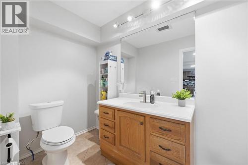 Bathroom with a wood-finish vanity, integrated sink, and track lighting - 450 East 42Nd Street, Hamilton, ON - Indoor Photo Showing Bathroom