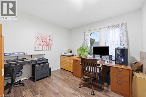 Spacious room featuring wood-finish flooring and a large window - 450 East 42Nd Street, Hamilton, ON - Indoor Photo Showing Office
