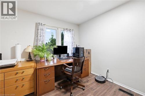Dedicated home office featuring wood-finish desk with ample storage, ergonomic task seating, and built-in cabinetry - 450 East 42Nd Street, Hamilton, ON - Indoor Photo Showing Office