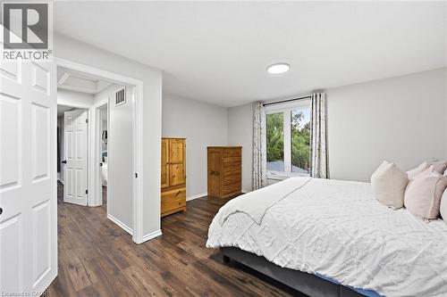 Spacious room featuring wood-finish flooring, white trim, and light gray walls - 450 East 42Nd Street, Hamilton, ON - Indoor Photo Showing Bedroom