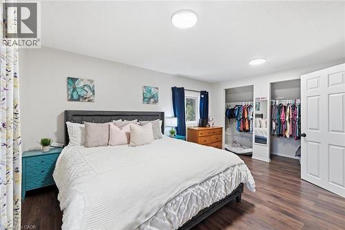 Spacious room featuring wood-finish flooring, light gray walls, and bright overhead lighting - 450 East 42Nd Street, Hamilton, ON - Indoor Photo Showing Bedroom